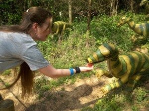 Alena feeds a tiny dinosaur